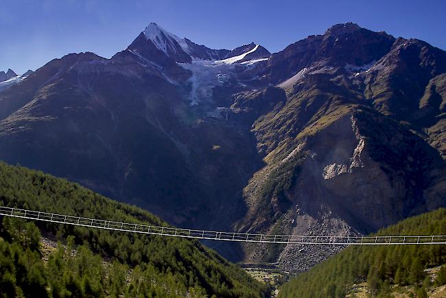 Kühn. Die weltweit längste hochalpine Fussgänger-Hängebrücke bei Randa (Fotomontage, im Hintergrund das Weisshorn) soll Wanderern auf dem Europaweg bereits im August 2017 zugänglich sein.
