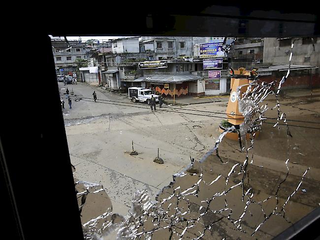 Blick durch ein durch Schüsse zerstörtes Fenster auf eine Strassenkreuzung in der Stadt Marawi, wo sich islamistische Rebellen und das philippinische Militär immer wieder heftige Gefechte liefern.