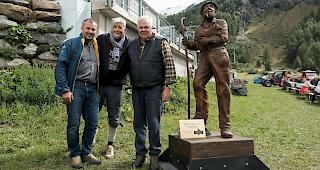 Daniel Luggen, Kurdirektor Zermatt Tourismus, &uuml;bergibt die Holzskulptur &laquo;Der Sch&auml;fer von Prato Borni&raquo; an Urs Biner, Erfinder von Wolli, und Ruedi Julen, Pr&auml;sident Zermatter Schwarznasen Schafzucht Genossenschaft.