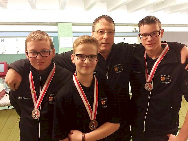 Die jungen Medaillengewinner Noé Noti, Jan Anthamatten und Tim Williner (vlnr). Im Hintergrund Coach Willy Venetz.