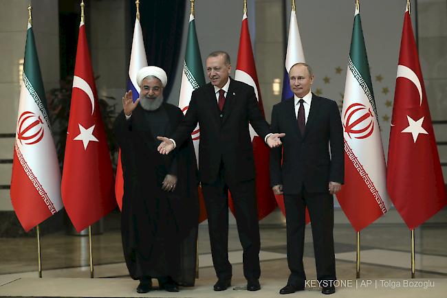 Putin, Erdogan und Ruhani bemühten sich auf einer gemeinsamen Medienkonferenz in Ankara um eine geschlossene Haltung.