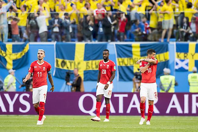 Die enttäuschten Schweizer Behrami, Djourou und Xhaka (von links) vor den Schweden-Fans.