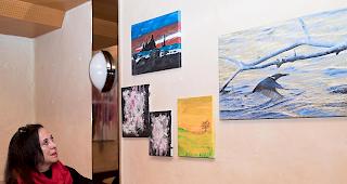 Katharina Manz, Betreiberin der Sonderbar in Brig, betrachtet die zu versteigernden Kunstwerke.