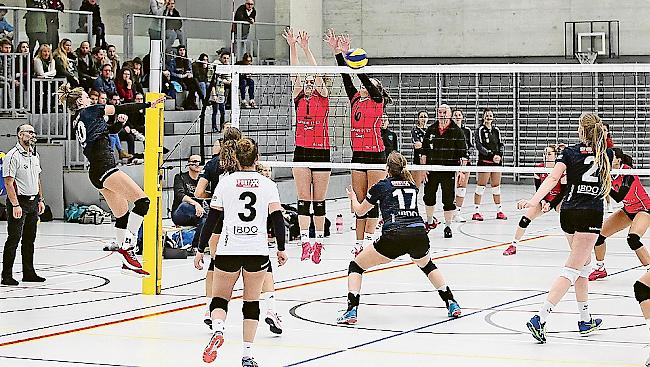 Melanie Wyer (roter Dress, Nummer 1) und Séverine Giroud (6) beim Block im Match gegen Münchenbuchsee.