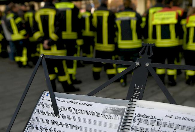 Feuerwehrmänner trauern am Sonntag auf dem Königsplatz in Augsburg mit dem Lied "Ich hatte einen Kameraden".
